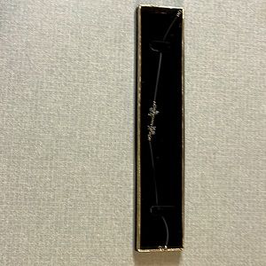 A bracelet with 6 small blue beads on leather straps